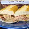 Bada Bing Supreme — French roll, hot ham, turkey, bacon bits, Swiss cheese, grilled onion, green & red peppers, and mayo