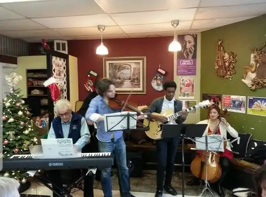 A band performing live inside Blue Heron for the neighborhood