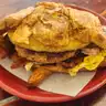 Croissant Breakfast Sandwich — Sausage, bacon, or ham, plus egg and cheese
