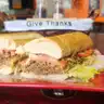 Philly Cheese Steak — French roll, beef or chicken, grilled onion, green & red peppers, cheese, lettuce, tomato, and mayo